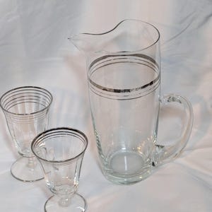 Early Mid-Century Pitcher and 2 pedestal glasses with classic silver banding