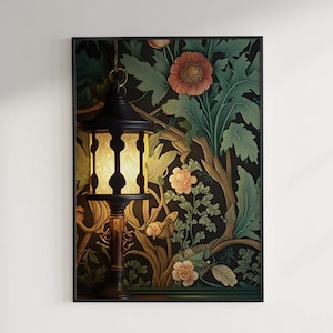 May include: A framed artwork featuring a black lantern with a warm glow, set against a backdrop of stylized floral and foliage patterns in shades of green, brown, and peach. The artwork is mounted on a white wall.