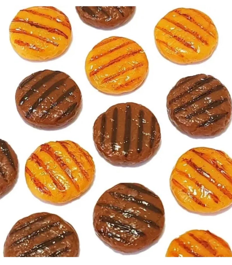 May include: A collection of 10 miniature, plastic, grilled hamburger patties. Five are brown and five are orange.