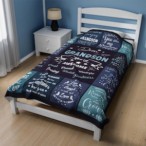 May include: A blue and green patterned throw blanket with the text "Dear Grandson You're Awesome" and other positive messages. The blanket is made of soft, comfortable fabric and is perfect for snuggling up on the couch or in bed.