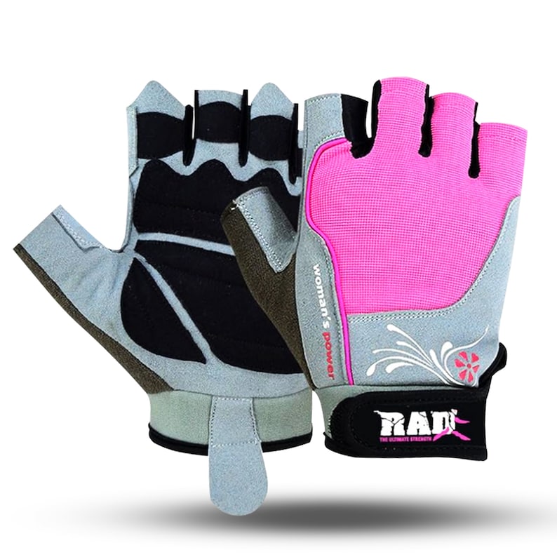 May include: A pair of gray and pink fingerless workout gloves with a black palm and a white floral design. The wrist strap is black with the text "RAD" in white and the text "THE ULTIMATE STRENGTH" in smaller white letters. The strap also has a pink and black graphic. The gloves have the text "Woman's Power" in red on the back.