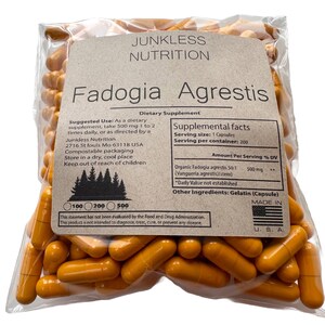 May include: A clear plastic bag filled with orange capsules. The bag has a label with the text "Junkless Nutrition Fadogia Agrestis Dietary Supplement." The label includes supplement facts and suggested use information. Made in the U.S.A.