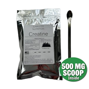 May include: A silver pouch of "Junkless Nutrition" Creatine dietary supplement with a label displaying nutritional information. A long, thin metal scoop and a green circle with "500 MG SCOOP Inside" text are also shown.