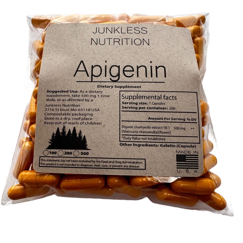 May include: A clear plastic bag filled with orange capsules. The bag has a brown label with the text "Junkless Nutrition" and "Apigenin." The label includes supplement facts and usage instructions. The capsules are a dietary supplement.