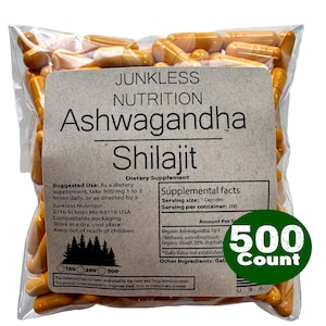 May include: A clear plastic bag filled with orange capsules. The bag has a label with the text "Junkless Nutrition Ashwagandha Shilajit Dietary Supplement." A green circle on the bag reads "500 Count."