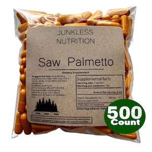 May include: A clear plastic bag filled with orange capsules labeled Junkless Nutrition Saw Palmetto Dietary Supplement. The label includes supplemental facts, a serving size of 1 capsule, and a green circular graphic indicating 500 Count.