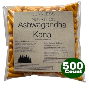 May include: A clear plastic bag filled with numerous yellow capsules. The bag has a label with the text "JUNKLESS NUTRITION Ashwagandha Kana Dietary Supplement." A green circle on the bag reads "500 Count."