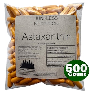 May include: A clear plastic bag filled with orange capsules. The label reads "Junkless Nutrition Astaxanthin Dietary Supplement." A green circle indicates "500 Count."
