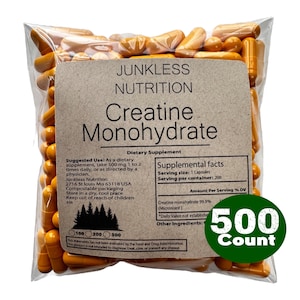 May include: A clear plastic bag filled with orange creatine monohydrate capsules. The bag has a brown label with the text "Junkless Nutrition Creatine Monohydrate." A green circle indicates a 500-count package.
