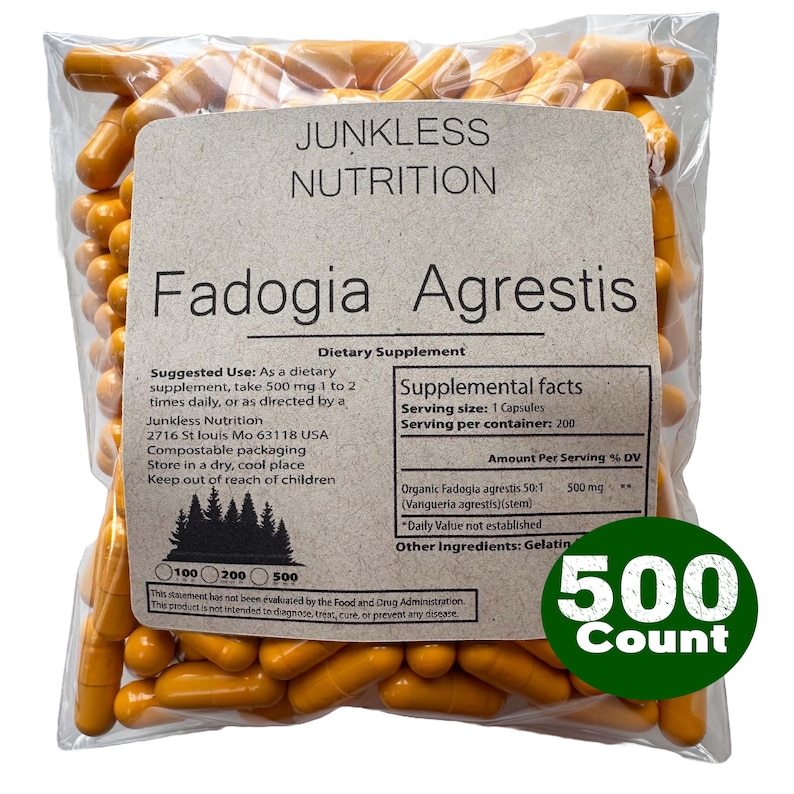 May include: A clear plastic bag filled with orange capsules. The bag has a label with the text "Junkless Nutrition Fadogia Agrestis Dietary Supplement." A green circle indicates a 500 count. The label also includes supplement facts and usage instructions.