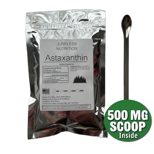 May include: A silver metallic pouch of Junkless Nutrition Astaxanthin dietary supplement with a white label featuring text and a forest graphic, accompanied by a long-handled metal scoop and a green circular badge reading 500 MG SCOOP Inside.
