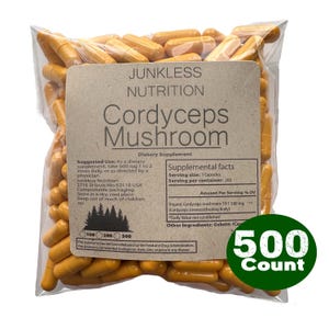 May include: A clear plastic bag filled with orange Cordyceps Mushroom capsules. A brown label displays the text "Junkless Nutrition Cordyceps Mushroom" and supplement facts. A green circle indicates a 500 count.