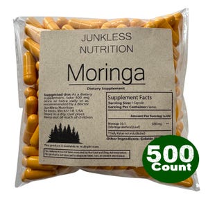 May include: A clear bag containing orange capsules. The label says "Junkless Nutrition Moringa Dietary Supplement." A green circle on the bottom right says "500 Count."