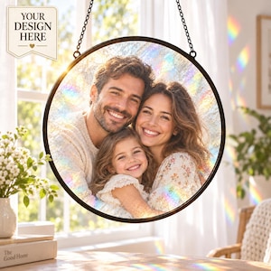 May include: A circular suncatcher featuring a custom photograph of a smiling family of three, including a man, a woman, and a young child. The image is encased in a dark metal frame with a hanging chain, displaying rainbow light refractions.