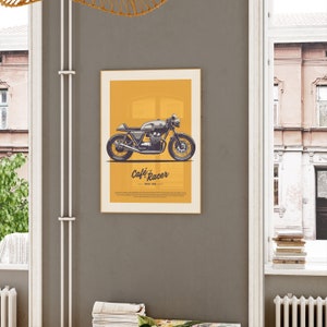 Image of a framed poster displayed on a dark wall showcasing a vintage Cafe Racer Bike