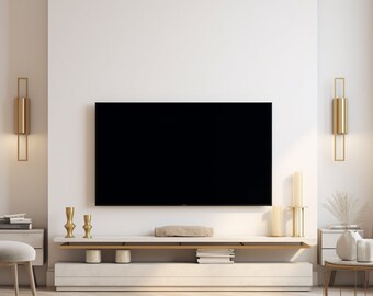 May include: A modern living room with a white wall, a black TV, a white entertainment center with gold accents, and a gold side table with a white vase and a plant.