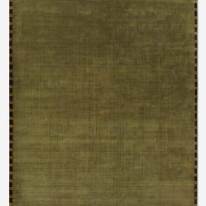 May include: A rectangular olive green rug with a textured surface. The rug has a border of alternating dark brown and tan rectangles. The rug is a solid color with a subtle woven pattern.