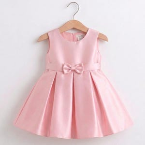 May include: A set of three ceramic mugs with a speckled, matte finish. The mugs are in shades of cream, light gray, and dark gray. Each mug has a simple, minimalist design and a rounded handle.