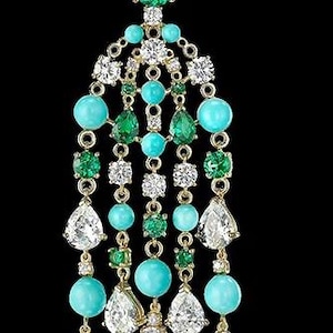 May include: A gold dangle earring with a pear-shaped diamond at the top, followed by a cascade of turquoise and emerald gemstones.