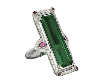 May include: A silver ring with a large green gemstone surrounded by smaller diamonds and pink gemstones.