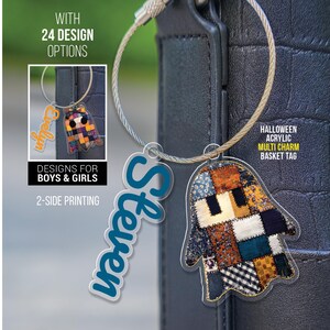 May include: A Halloween-themed acrylic multi-charm basket tag with a ghost-shaped design. The tag features a patchwork pattern in various colors and is attached to a silver-colored wire loop. The name "Steven" is printed on a blue tag.