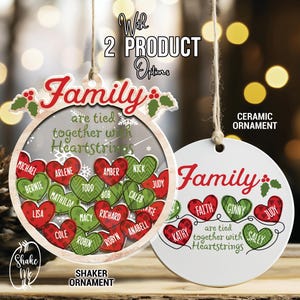 May include: A set of two Christmas ornaments featuring a red and green heart design with the text "Family are tied together with heartstrings". One ornament is a shaker ornament with a clear plastic dome and the other is a ceramic ornament.