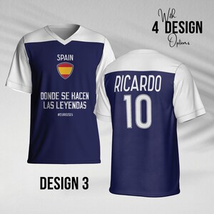 May include: A blue and white soccer jersey with the text "SPAIN" and the Spanish flag logo. The text "DONDE SE HACEN LAS LEYENDAS #EURO2024" is printed below the logo. The back of the jersey has the text "RICARDO 10" printed in white.