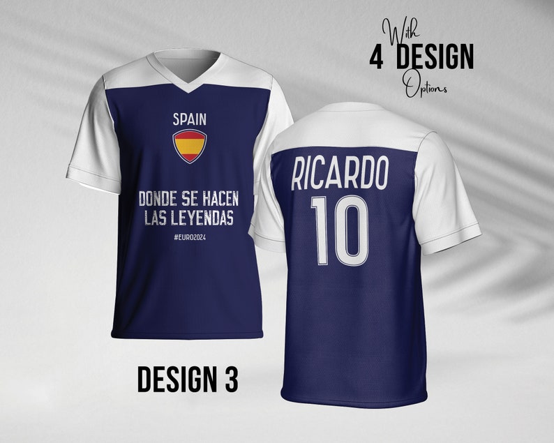 May include: A blue and white soccer jersey with the text "SPAIN" and the Spanish flag logo. The text "DONDE SE HACEN LAS LEYENDAS #EURO2024" is printed below the logo. The back of the jersey has the text "RICARDO 10" printed in white.