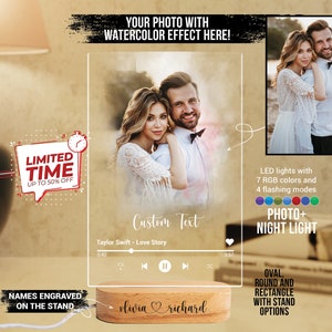May include: A custom photo night light with a watercolor effect of a couple. The light has a wooden base with the names "olivia richard" engraved on it. The light has a music player feature with the song "Taylor Swift - Love Story" playing. The light has 7 RGB colors and 4 flashing modes.