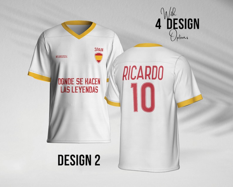 May include: White soccer jersey with yellow trim and red accents. The front of the jersey has the text "#EURO2024", "SPAIN", and "DONDE SE HACEN LAS LEYENDAS". The back of the jersey has the text "RICARDO" and the number "10".