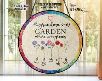 May include: A round stained glass suncatcher with a black frame. The center features the text "grandma's GARDEN where love grows" with a heart and flower illustrations. Names are listed below the flowers. The border has a colorful design.