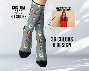 May include: Custom face fit socks with a blue and white pattern featuring faces and cats. The socks are shown on a model's legs. The text "CUSTOM FACE FIT SOCKS" is in the top left corner of the image. The text "YOUR PHOTO IS HERE" is in the top right corner of the image. The text "36 COLORS 6 DESIGN" is in the bottom center of the image.