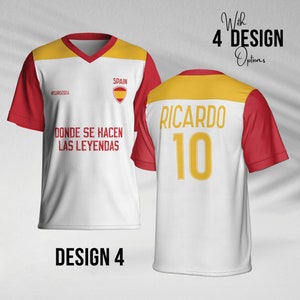 May include: White soccer jersey with red and yellow accents. The front of the jersey has the text "SPAIN" and "#EURO2024" and the text "DONDE SE HACEN LAS LEYENDAS". The back of the jersey has the text "RICARDO" and the number "10".