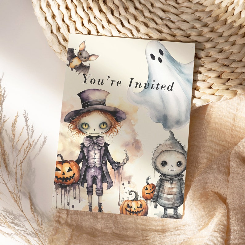 May include: A Halloween invitation card with a spooky cartoon illustration of a ghost, a bat, and two skeletons. The card says "You're Invited".
