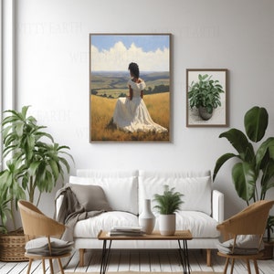 May include: A painting depicting a woman in a white dress seated in a field of long grass. The woman is facing away from the viewer, with her back to the camera. The painting is framed in a wooden frame and is hanging on a white wall.