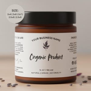 Peut inclure: Un pot brun avec un couvercle noir et une étiquette blanche. L'étiquette indique "Your Business Name" et "Organic Product". Le pot contient 180 g de produit et est étiqueté naturel, végétalien et sans cruauté.