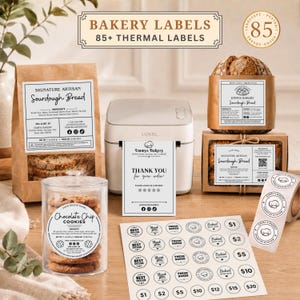 May include: A collection of bakery labels and thermal printer supplies including a Luxel thermal printer, a brown paper bag of sourdough bread, a clear jar of chocolate chip cookies, a loaf of bread, a box of cookies, and sheets of round stickers.