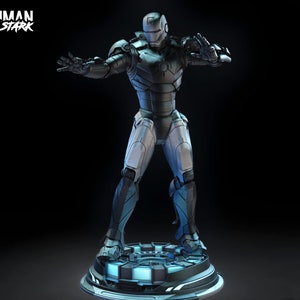 May include: A detailed figurine of Iron Man, in a silver and black armored suit, standing on a circular platform with blue lighting. The figure is posed with arms outstretched. The text "IRONMAN TONY STARK" is in the upper left corner.