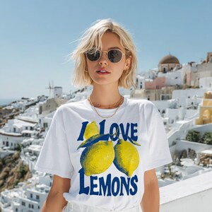 I Love Lemons t-shirt design featuring three hand-drawn yellow lemons with blue shading and bold retro blue text that says “I LOVE LEMONS.” A vibrant summer fruit graphic perfect for sublimation, printable t-shirts, summer merch, lemon-themed gifts, or wall art. Includes high-resolution PNG and PDF files for instant download. Ideal for fruit lovers, bold fashion, and sunny summer apparel.