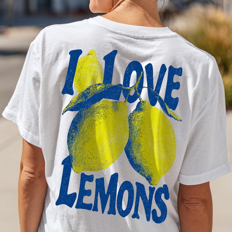 I Love Lemons t-shirt design featuring three hand-drawn yellow lemons with blue shading and bold retro blue text that says “I LOVE LEMONS.” A vibrant summer fruit graphic perfect for sublimation, printable t-shirts, summer merch, lemon-themed gifts, or wall art. Includes high-resolution PNG and PDF files for instant download. Ideal for fruit lovers, bold fashion, and sunny summer apparel. Gift for Her, gift for him.