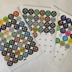 May include: Four sheets of stickers with colour swatches for different paint colours. The stickers are labelled with numbers and letters, such as XF-1, XF-2, XF-3, and X-3, X-5, X-6. The colours include black, white, red, blue, green, yellow, brown, grey, and orange.
