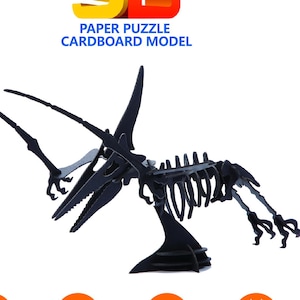 May include: A 3D paper puzzle model of a Pterosaurs skeleton. The box is orange and features the text "PTEROSAUR" in black. The puzzle is rated 6+ years and has a difficulty level of 2 stars. The box also states that the puzzle takes 0.2 to 0.5 hours to complete.