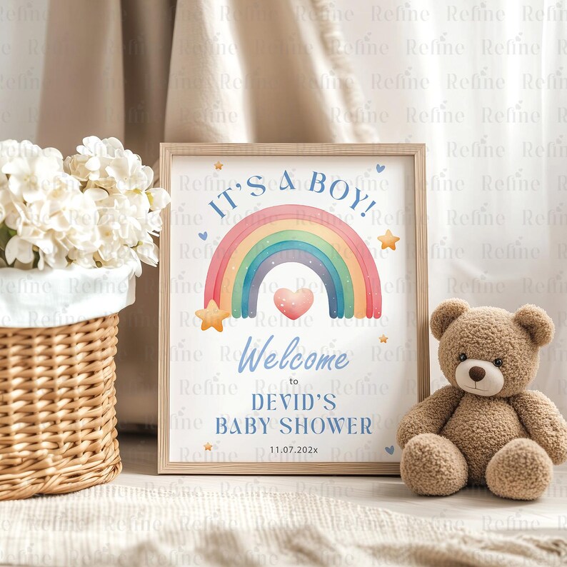 May include: A baby shower sign with a rainbow and stars. The sign says "It's a Boy!" and "Welcome to Devid's Baby Shower 11.07.202x".
