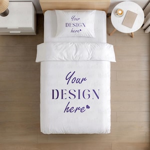 May include: White bedding set with a pillow and duvet cover. The pillow and duvet cover feature the text "Your DESIGN here" in a dark purple color. The bedding is neatly arranged on a bed.