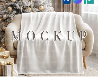 May include: A white blanket draped over a beige sofa, with the word "MOCKUP" in large letters across the front. The background includes a decorated Christmas tree and wrapped gifts. The text "PSD SMART OBJECT + CANVA TEMPLATE" is at the bottom.