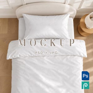 May include: A white bedding set featuring a pillowcase and a duvet cover on a bed. The text MOCKUP and PSD + JPG is centered on the duvet. The fabric has a repeating watermark pattern of the word Refine. A small blue Ps icon and a teal icon are visible.