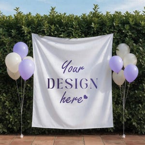 May include: A white banner with the text "Your DESIGN here" in purple, flanked by clusters of balloons in white and lavender. The banner hangs in front of a green hedge, creating a backdrop for events.