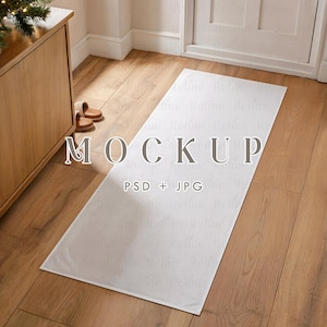 May include: A white rectangular doormat with the word "MOCKUP" printed on it. The text "PSD + JPG" is also visible. The doormat is placed on a wooden floor, near a wooden cabinet and a door.
