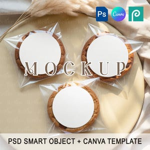 May include: Three chocolate chip cookies in clear plastic packaging, each with a white circular label. The word "MOCKUP" is printed across the cookies. The image also includes the text "PSD SMART OBJECT + CANVA TEMPLATE".