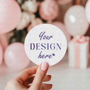 May include: A white round sticker with the text "Your DESIGN here" in purple lettering and a small purple heart.